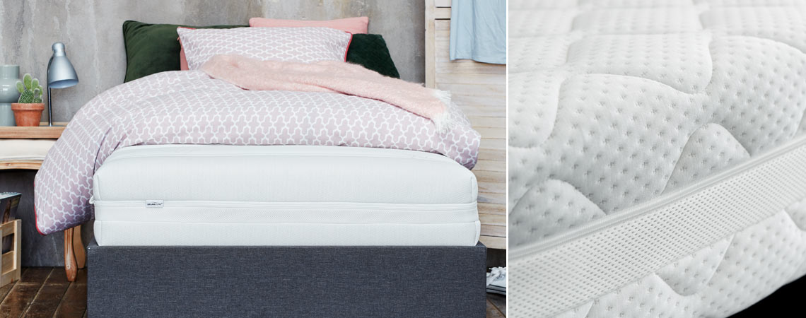 Bett mit Matratze, Kopfkissen und Bettwäsche mit Wolldecke