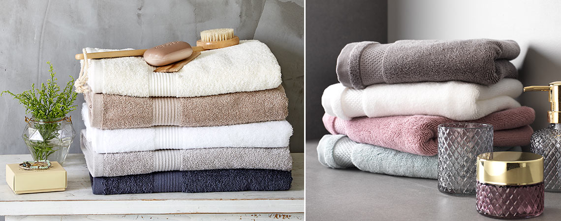 Handtücher aus 100% Baumwolle an Haken aufgehängt und ordentlich gefaltet