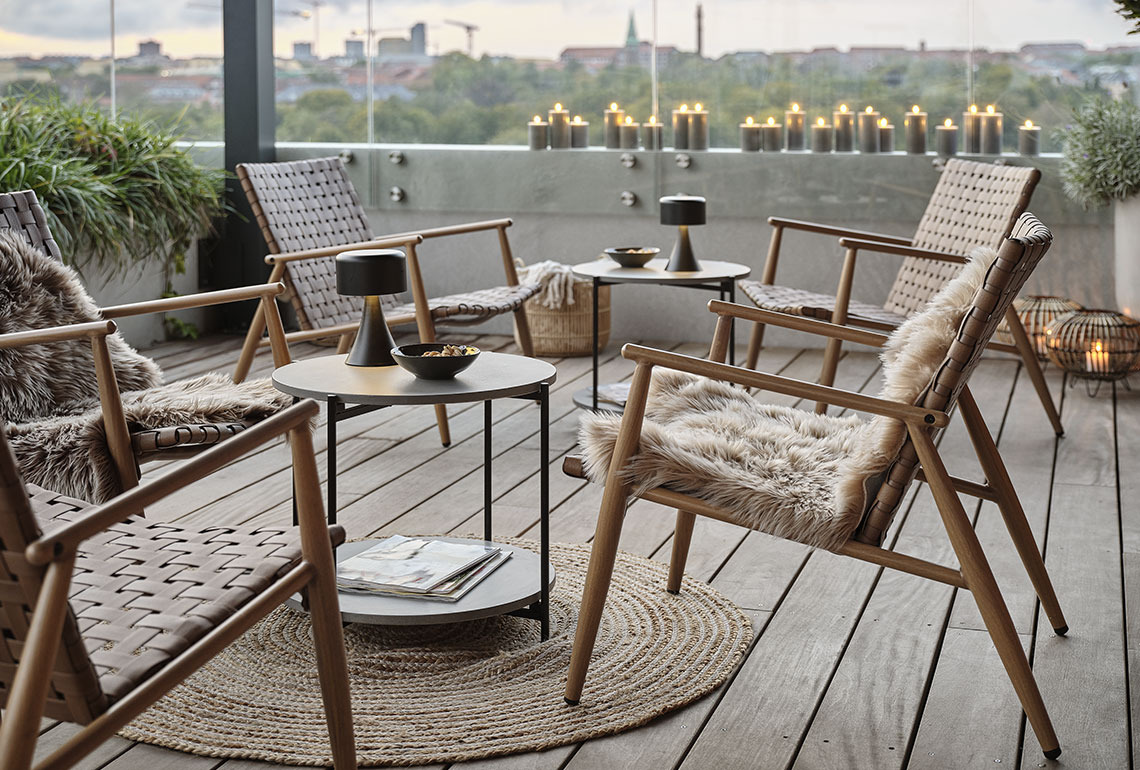 Garten-Lounge-Sessel und Tische auf einem gemütlichen Balkon