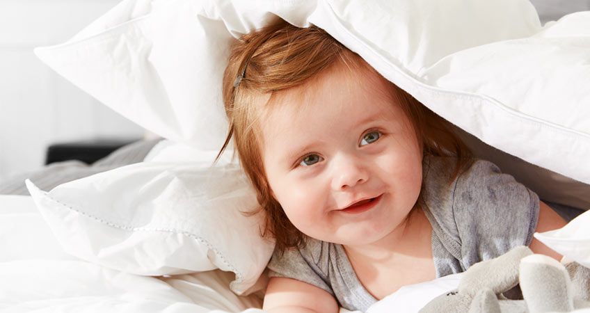 Baby unter einer Bettdecke